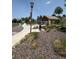 Community playground with swings, a covered picnic area, and a paved walkway at 6323 S Sicily Way, Aurora, CO 80016