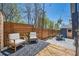 Cozy backyard with a wooden deck, patio seating, and a charming wooden fence at 2942 Chase St, Wheat Ridge, CO 80214