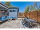 Inviting backyard featuring patio seating, a wooden deck, and stylish exterior finishes at 2942 Chase St, Wheat Ridge, CO 80214