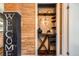 Custom bar area featuring wooden shelving, elegant lighting, and decorative accents with a built-in wine rack at 2942 Chase St, Wheat Ridge, CO 80214