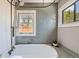 Bright bathroom featuring a classic tub with tiled walls and ample natural light at 2942 Chase St, Wheat Ridge, CO 80214
