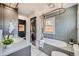 Charming bathroom featuring blue tiling, stackable washer/dryer, and a stylish vanity at 2942 Chase St, Wheat Ridge, CO 80214