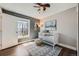 Bright bedroom with a modern crib, cozy rug, and plenty of natural light, creating a serene atmosphere at 2942 Chase St, Wheat Ridge, CO 80214
