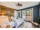 Inviting bedroom with sliding glass doors to a balcony, offering plenty of natural light and comfortable bedding at 2942 Chase St, Wheat Ridge, CO 80214