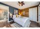 Cozy bedroom features a decorative wood wall, soft lighting, and stylish decor, creating a peaceful sanctuary at 2942 Chase St, Wheat Ridge, CO 80214