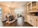 Dining room showcasing hardwood floors, modern chandelier, and open layout to living room at 2942 Chase St, Wheat Ridge, CO 80214