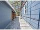 Exterior side view of home featuring a long stone walkway and wood and stone siding at 2942 Chase St, Wheat Ridge, CO 80214