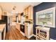Bright kitchen with wooden cabinetry, updated appliances, and a cozy dining nook in an open-concept design at 2942 Chase St, Wheat Ridge, CO 80214