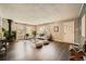 Spacious living room with hardwood floors, a vintage fireplace and large windows providing natural light at 2942 Chase St, Wheat Ridge, CO 80214