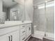 Bright bathroom features double sinks, quartz counters, modern black fixtures, and a glass-enclosed shower at 23692 E 40Th Ave, Aurora, CO 80019