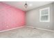 Empty bedroom with pink accent wall at 23692 E 40Th Ave, Aurora, CO 80019