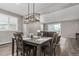 Open-concept dining room featuring hardwood floors and a modern light fixture at 23692 E 40Th Ave, Aurora, CO 80019