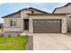 Charming single Gathering home featuring a two-car garage, stone accents, and manicured lawn at 23692 E 40Th Ave, Aurora, CO 80019