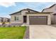 Charming single Gathering home featuring a two-car garage, stone accents, and manicured lawn at 23692 E 40Th Ave, Aurora, CO 80019