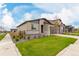 Charming single Gathering home featuring a two-car garage, stone accents, and manicured lawn at 23692 E 40Th Ave, Aurora, CO 80019