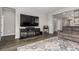 Comfortable living room featuring hardwood floors, neutral paint, and a modern entertainment center at 23692 E 40Th Ave, Aurora, CO 80019