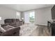 Comfortable living room featuring hardwood floors, neutral paint, and a sliding glass door to the patio at 23692 E 40Th Ave, Aurora, CO 80019