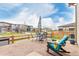 Cozy outdoor seating area with a wooden rocking chair and nearby community views at 23692 E 40Th Ave, Aurora, CO 80019