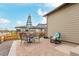 Back patio with outdoor dining area with umbrella and a rocking chair at 23692 E 40Th Ave, Aurora, CO 80019