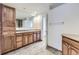 Bathroom with a large mirror, wooden cabinets and drawers, plus tile flooring at 5749 S Lansing Way, Englewood, CO 80111