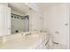 Well-lit bathroom with a wide countertop, framed mirror, and tiled floors at 5749 S Lansing Way, Englewood, CO 80111