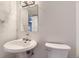 Half bathroom with modern fixtures and a neutral color scheme at 5749 S Lansing Way, Englewood, CO 80111