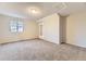 Cozy bedroom with plush carpeting, a large window, and neutral wall color at 5749 S Lansing Way, Englewood, CO 80111