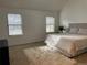 Bright bedroom featuring two large windows, plush carpeting, and a comfortable bed with decorative pillows at 5749 S Lansing Way, Englewood, CO 80111