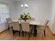 Formal dining room features a modern chandelier, hardwood floors, and stylish seating for elegant gatherings at 5749 S Lansing Way, Englewood, CO 80111