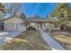Charming ranch-style home with a well-manicured lawn and two-car garage under a clear blue sky at 5749 S Lansing Way, Englewood, CO 80111