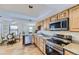 Updated kitchen featuring stainless steel appliances, granite countertops, and wood cabinetry at 5749 S Lansing Way, Englewood, CO 80111