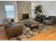 Comfortable living room with stone fireplace, plush seating, stylish rug, and plenty of natural light at 5749 S Lansing Way, Englewood, CO 80111