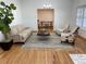 Inviting living room featuring hardwood floors, stylish seating, a modern rug, and a view to the office at 5749 S Lansing Way, Englewood, CO 80111