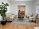 Inviting living room featuring hardwood floors, stylish seating, a modern rug, and a view to the office at 5749 S Lansing Way, Englewood, CO 80111