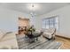 Inviting living room with hardwood floors, a bay window, and stylish furnishings at 5749 S Lansing Way, Englewood, CO 80111