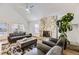 Spacious living room with a stone fireplace and a vaulted ceiling at 5749 S Lansing Way, Englewood, CO 80111