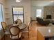Cozy kitchen nook flows into the open living room with stone fireplace and hardwood floors at 5749 S Lansing Way, Englewood, CO 80111