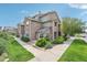 Charming townhome with stone facade, well-manicured landscaping, and inviting walkway at 2502 S Bahama Cir # B, Aurora, CO 80013