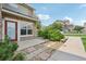 Charming exterior features a red door, stone accents, and mature landscaping at 2502 S Bahama Cir # B, Aurora, CO 80013