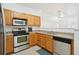 Well-equipped kitchen features stainless steel appliances, tile flooring, and light wood cabinetry at 2502 S Bahama Cir # B, Aurora, CO 80013