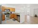 Modern kitchen with stainless steel appliances, tile floors, and natural light at 2502 S Bahama Cir # B, Aurora, CO 80013