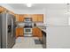 Well-equipped kitchen with stainless appliances, tile flooring, and ample counter space at 2502 S Bahama Cir # B, Aurora, CO 80013