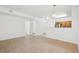 Open living space with neutral tile floors and a view of the kitchen at 2502 S Bahama Cir # B, Aurora, CO 80013