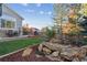 Well-manicured backyard featuring a water feature, seating area, and grass; perfect for outdoor relaxation and entertaining at 2170 Mountain Iris Dr, Erie, CO 80516