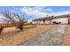 White home features a lovely back deck and expansive rock-landscaped backyard with a fire pit area at 16555 E Wesley Ave, Aurora, CO 80013