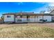 Backyard of a single story home featuring gravel area, lawn, and covered patio at 16555 E Wesley Ave, Aurora, CO 80013