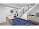Basement featuring game and entertainment area with billiards, living space, and carpeted stairs at 16555 E Wesley Ave, Aurora, CO 80013