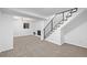Finished basement featuring plush carpeting, a fireplace, and modern staircase with black metal banisters at 16555 E Wesley Ave, Aurora, CO 80013