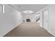 Spacious finished basement with plush carpeting, a modern fireplace, and contemporary lighting at 16555 E Wesley Ave, Aurora, CO 80013