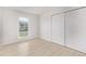 Bedroom with bright, natural light from window, light wood floor, and closet with sliding doors at 16555 E Wesley Ave, Aurora, CO 80013